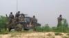 FILE - Afghan soldiers fire a machine gun during a gun battle with Taliban forces in Afghanistan's northern Baghlan province, April 15, 2010.