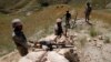 Afghan border policemen take their positions at the Goshta district of Nangarhar province border, where Afghanistan shares borders with Pakistan, May 2, 2013. An Afghan border policeman was killed and two Pakistani soldiers were wounded in an exchange of 