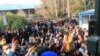 FILE - In this Saturday, Dec. 30, 2017 file photo taken by an individual not employed by the Associated Press and obtained by the AP outside Iran, university students attend a protest inside Tehran University while anti-riot Iranian police prevent them to