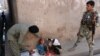 An Afghan health worker administers polio drops to a child during a polio vaccination campaign in the Surkh Rod district of Nangarhar province.