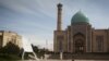 FILE - A boy plays with a kite at Khast Imam square in Tashkent, Uzbekistan.