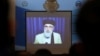 FILE - A screen shows the broadcast of Gulbuddin Hekmatyar during a signing ceremony with Afghan government at the presidential palace in Kabul, Afghanistan, Sept. 29, 2016.