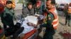 Pakistani rescue workers remove a body from the site of a deadly bombing in the eastern city of Lahore, Pakistan, July 24, 2017. 