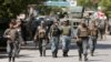 Afghan policemen arrive at the site of an attack and gun fire in Kabul, May 9, 2018. 