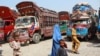 FILE - Afghan refugees living in Pakistan arrive at the UNHCR's Repatriation Center en route to Afghanistan, in Peshawar, Pakistan.