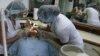 Two dentists work on a U.S. patient at a dental clinic in San Jose, Costa Rica. REUTERS/Juan Carlos Ulate 