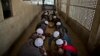 In this Feb. 1, 2015 photo, Pakistani students of a madrassa, or Islamic school, eat their lunch at their seminary in Islamabad, Pakistan. 