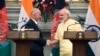 Indian Prime Minister Narendra Modi, right, shakes hands with Afghan President Ashraf Ghani after signing of bilateral agreements in New Delhi, India, Wednesday, Sept. 14, 2016.