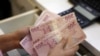 FILE PHOTO: A money changer counts Turkish lira bills at an currency exchange office in central Istanbul, Turkey