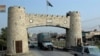 A security escort vehicle followed by a truck load of supplies drive past Khayber pass November 17, 2008. Pakistani security forces escorted a truck convoy carrying supplies for Western forces in Afghanistan on Monday as Pakistan reopened the Khyber Pass 